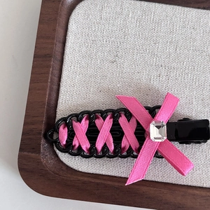 Pink ribbon ballet-style seamless hair clip with black chain and crystal detail