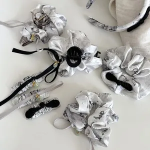 Detail of Chinese ink-style hair accessories featuring jade beads and silk bows