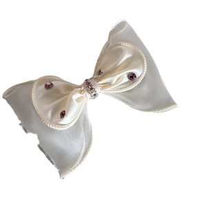 Pince à cheveux nœud blanc crème avec pierres violettes et détails en ruban organza