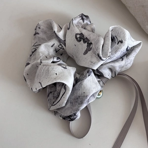 Detail of silk satin scrunchie with ink wash pattern and jade bead pendant