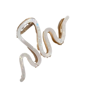 Elegant white pearlescent wave hair claw clip with golden frame and S-shaped design