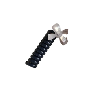 Spiral telephone cord hair tie with translucent cream bow and blue resin band