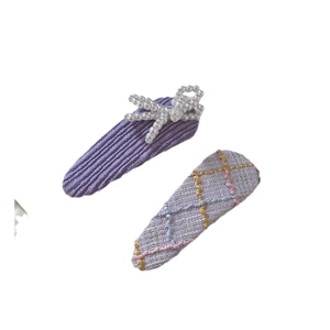 Set of two girls' hair clips featuring a pearl bow and purple plaid woven design