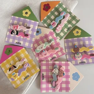 Detail of cute pastel wave hair clips with cartoon bears and stars on a house card