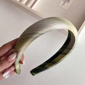 Detail of sage green gradient fabric headband with premium satin silk texture