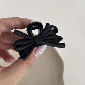Elegant black satin bow hair claw clip for voluminous ballet-style hairstyles