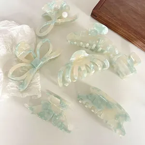 Elegant mint green acetate hair claw clips set with marble texture and pearl details