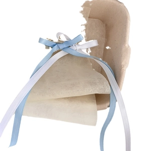 Ballet style double layer bow hair clips with silk ribbons on a display tray