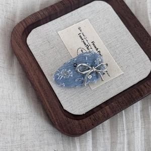 Blue denim bow hair clip with silver metal butterfly and sequin details for women