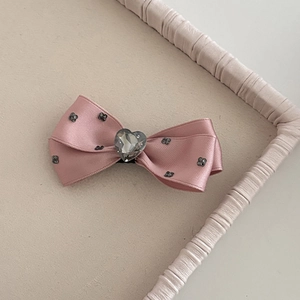 Pink satin bow hair clip with crystal heart and black floral accents for girls