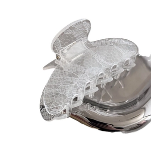 Elegant medium lace shark clip with white floral patterns on clear acrylic base