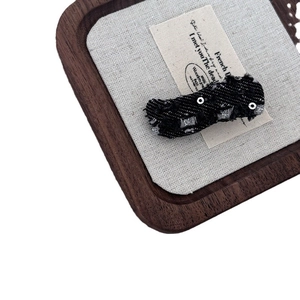 Denim bow hair clip with silver studs and frayed edges for a vintage aesthetic style