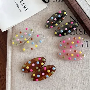 Set of retro colorful polka dot acetate hair clips in multiple shades for women