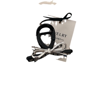 Pince à cheveux élégante avec nœud noir et argent accessoire de coiffure chic pour femme