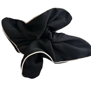 Classic black scrunchie with white piped edges and elegant minimalist pleated design