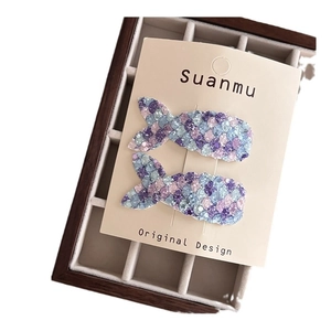 Glittery mermaid tail hair clips for girls featuring colorful blue and pink sequins