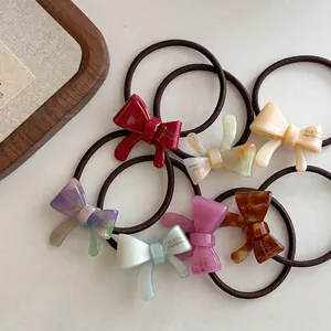 Set of 7 colorful handmade bow hair ties featuring acetate charms and elastic bands