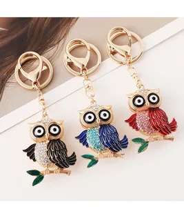 Détail de porte-clés chouette colorés avec strass et ailes en émail en trois options de couleur