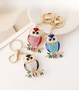 Detailed macro of crystal owl keychains with colorful enamel and gold metal finish