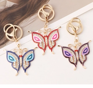 Close-up of three colorful butterfly keychains with crystal rhinestones and gold alloy edges
