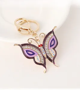 Detailed close-up of a purple enamel butterfly keychain with sparkling crystal rhinestones