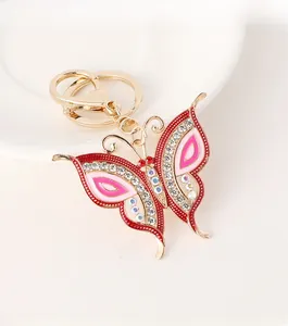 Detailed macro view of colorful crystal butterfly keychain with golden metal finish