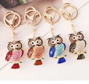 Detailed macro view of four colorful rhinestone owl keychains with premium lobster clasps