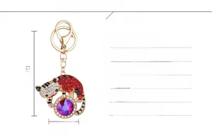 Porte-clés chat scintillant avec strass rouges et pierre violette, dimensions 12.1x5.7cm