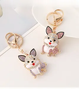 Macro shot of cute dog keychains with colorful crystals and enamel finish on gold alloy