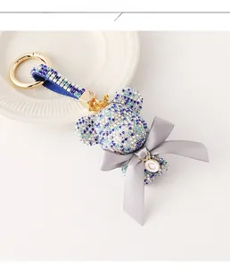 Detailed macro view of a rhinestone bear keychain with crown and personalized letter C tag