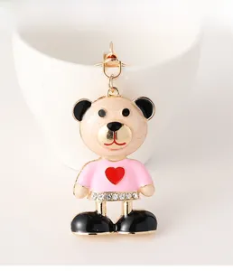 Close-up of the champagne bear keychain featuring a red heart and sparkling rhinestones