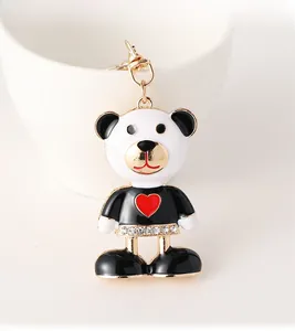 Close-up of enamel panda keychain with red heart and sparkling rhinestones on golden metal