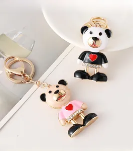 Detail of cartoon bear keychain with red heart and sparkling rhinestone waist belt