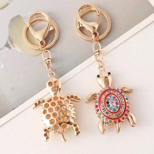 Colorful turtle keychain with sparkling crystals and a red enamel shell on gold alloy
