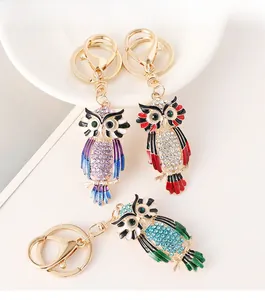 Detailed close-up of colorful rhinestone owl keychains in purple, red, and blue shades