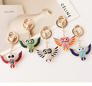 Détail de porte-clés hibou colorés avec strass brillants et finition dorée
