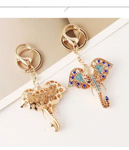 Detail showing crystal elephant keychains with blue rhinestones and gold cut-out patterns