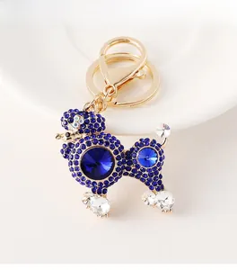 Macro shot of poodle keychain with dark blue rhinestones and faceted crystals