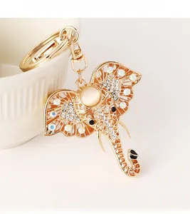 Detail of golden elephant keychain with sparkling rhinestones and opal stone inlay
