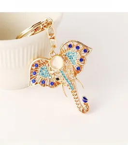 Macro view of gold elephant keychain with blue rhinestones and white gemstone detail