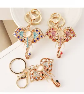 Detail of golden elephant keychain featuring colorful rhinestones and opal stone inlay