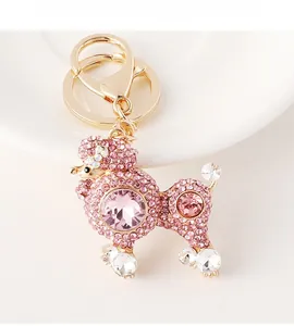 Detailed macro view of gold-plated poodle keychain with pink rhinestones and crystal accents