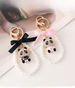 Detailed view of panda keychains with sparkling rhinestones and elegant pearl beads