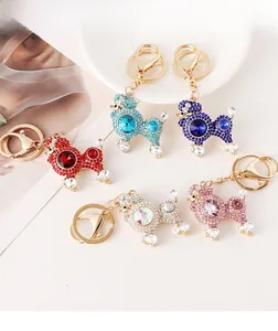 Detailed collection of crystal poodle keychains in five colors on a decorative tray
