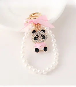 Detail of crystal panda keychain with pink bow and elegant faux pearl ring loop