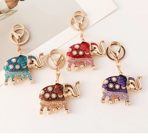 Detail view of colorful elephant keychains with enamel flowers and sparkling rhinestones