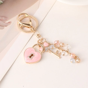 Exquisite golden heart lock keychain with sparkling pink crystals and diamond accents