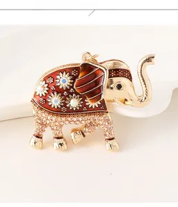 Detail of elephant keychain with red enamel and champagne crystals on golden base