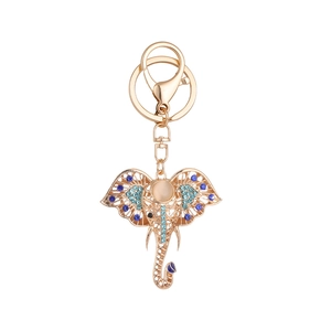 Golden elephant keychain with blue rhinestones and cat-eye stone in a cutout design