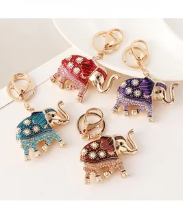 Detailed macro view of four colorful rhinestone elephant keychains in various finishes